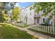 Townhouses with fenced-in front yards, landscaping, and trees at 330 Gilman Ln # 109, Raleigh, NC 27610