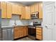 Well-equipped kitchen with stainless steel appliances, granite countertops, and a stylish tile backsplash at 330 Gilman Ln # 109, Raleigh, NC 27610