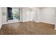 Bright living room with hardwood floors, a large window, and an entry doorway at 330 Gilman Ln # 109, Raleigh, NC 27610