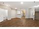 Spacious living room with hardwood floors connecting to the kitchen and stairs at 330 Gilman Ln # 109, Raleigh, NC 27610
