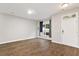 Empty living room with hardwood floors, natural light, and entry door at 330 Gilman Ln # 109, Raleigh, NC 27610