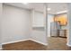 Open-concept living space with hardwood floors seamlessly connecting the dining area, stainless steel appliances, and kitchen at 330 Gilman Ln # 109, Raleigh, NC 27610