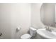 A half bathroom featuring a toilet and sink with mirror at 341 Henry Steel Dr, Gibsonville, NC 27249