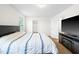 Spacious bedroom featuring a comfortable bed, modern TV set, and bright natural light, with an en suite bathroom at 341 Henry Steel Dr, Gibsonville, NC 27249