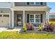 Inviting front porch with stylish seating and landscaping enhancing curb appeal at 341 Henry Steel Dr, Gibsonville, NC 27249