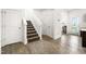 Hallway with hardwood floors, a staircase, and access to a well-lit room at 341 Henry Steel Dr, Gibsonville, NC 27249