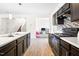 A lovely kitchen featuring dark cabinets, stainless appliances, and a center island with a double sink at 341 Henry Steel Dr, Gibsonville, NC 27249
