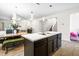 A lovely kitchen featuring dark cabinets, stainless appliances, and a center island with a double sink at 341 Henry Steel Dr, Gibsonville, NC 27249