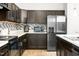 A lovely kitchen featuring dark cabinets, stainless appliances, and a center island with a double sink at 341 Henry Steel Dr, Gibsonville, NC 27249