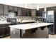 A lovely kitchen featuring dark cabinets, stainless appliances, and a center island with a double sink at 341 Henry Steel Dr, Gibsonville, NC 27249