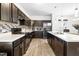A lovely kitchen featuring dark cabinets, stainless appliances, and a center island with a double sink at 341 Henry Steel Dr, Gibsonville, NC 27249
