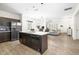 A lovely kitchen featuring dark cabinets, stainless appliances, and a center island with a double sink at 341 Henry Steel Dr, Gibsonville, NC 27249