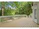 Spacious back deck perfect for outdoor entertaining, featuring a white railing and beautiful wooded backyard views at 3705 Old Post Rd, Raleigh, NC 27612