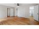This large bedroom has hardwood floors, ceiling fan, doors and a walk in closet at 3705 Old Post Rd, Raleigh, NC 27612