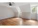 Large bedroom with hardwood floors, natural lighting and a ceiling fan at 3705 Old Post Rd, Raleigh, NC 27612