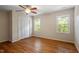 Bedroom with hardwood floors, neutral paint, and natural light from two windows at 3705 Old Post Rd, Raleigh, NC 27612