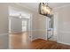 Open-concept dining room featuring hardwood floors and connecting to the kitchen at 3705 Old Post Rd, Raleigh, NC 27612