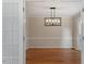 Inviting dining room with hardwood floors and elegant lighting fixture at 3705 Old Post Rd, Raleigh, NC 27612