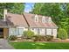 Close-up view of a charming home with a manicured lawn and a dormer window at 3705 Old Post Rd, Raleigh, NC 27612
