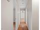 Hallway with hardwood floors and access to multiple rooms at 3705 Old Post Rd, Raleigh, NC 27612