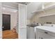 Laundry room with washer, dryer, and shelving near the stairs at 3705 Old Post Rd, Raleigh, NC 27612