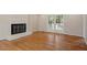 Spacious living room with hardwood floors, fireplace, and French door to outdoor deck at 3705 Old Post Rd, Raleigh, NC 27612