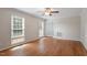 Bright living room with hardwood floors and modern ceiling fan at 3705 Old Post Rd, Raleigh, NC 27612