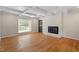 Living room features a fireplace, hardwood floors, and ample natural light at 3705 Old Post Rd, Raleigh, NC 27612