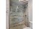 Modern glass shower with grey marble styled tile and brushed metal fixtures at 3705 Old Post Rd, Raleigh, NC 27612