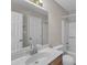 A well-lit bathroom featuring a large mirror over a sink, with a tub and toilet at 410 Oak Run Dr, Raleigh, NC 27606