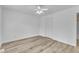 An empty bedroom featuring modern vinyl plank floors, ceiling fan, with a closet and neutral walls at 410 Oak Run Dr, Raleigh, NC 27606