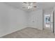 Neutral bedroom with carpet, a ceiling fan, double closet, and an ensuite bathroom entrance at 410 Oak Run Dr, Raleigh, NC 27606
