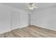 A bright bedroom featuring new floors, a ceiling fan, and neutral walls, with a closet at 410 Oak Run Dr, Raleigh, NC 27606