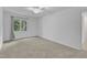 Bright bedroom with neutral carpet, ceiling fan, and natural light from the window at 410 Oak Run Dr, Raleigh, NC 27606