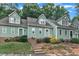 Charming townhouse exterior showcasing well-maintained landscaping and a welcoming entrance with inviting stairs and white railing at 410 Oak Run Dr, Raleigh, NC 27606