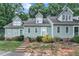Inviting exterior of a townhouse with a manicured lawn and appealing architectural details and concrete steps and white rails at 410 Oak Run Dr, Raleigh, NC 27606