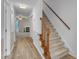 Inviting foyer featuring wood laminate flooring, leading to stairs and an archway, offering a glimpse into the living area at 410 Oak Run Dr, Raleigh, NC 27606
