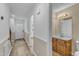 Inviting hallway with wood-look flooring leads to a half bath and the front door at 410 Oak Run Dr, Raleigh, NC 27606