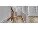 Bright foyer featuring hardwood floors, white walls with tan trim, and front door at 410 Oak Run Dr, Raleigh, NC 27606
