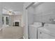 Convenient laundry room with washer, dryer, and wire shelving next to the living room at 410 Oak Run Dr, Raleigh, NC 27606