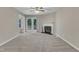 Bright living room featuring a cozy fireplace and patio access to the outdoors at 410 Oak Run Dr, Raleigh, NC 27606