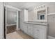 Bathroom showcasing white vanity with granite countertop, built-in storage, and neutral tile flooring at 413 E Center St, Nashville, NC 27856
