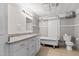 Renovated bathroom featuring white cabinets, granite counters, and a claw foot tub at 413 E Center St, Nashville, NC 27856