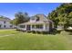 Charming two-story home with a screened-in porch, lush lawn, and mature trees at 413 E Center St, Nashville, NC 27856