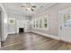 Inviting living room featuring a decorative fireplace, white trim, and new wood-look floors at 413 E Center St, Nashville, NC 27856