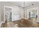 Open-concept living area with wood-look floors, chandelier, and decorative fireplace at 413 E Center St, Nashville, NC 27856