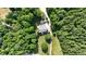An aerial view captures the home's setting within a lush, wooded landscape, offering privacy and serene views at 4217 Grahamstone Rd, Raleigh, NC 27610