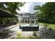 A multi-level backyard features ample patio seating, a fire pit, and lush green grass at 4217 Grahamstone Rd, Raleigh, NC 27610