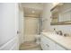 Bathroom featuring light fixtures, white fixtures, and wood-look floors at 4217 Grahamstone Rd, Raleigh, NC 27610