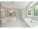Spacious bathroom featuring a soaking tub, double vanity, and tiled floors at 4217 Grahamstone Rd, Raleigh, NC 27610